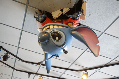 Look up - it's Stitch coming through the ceiling!