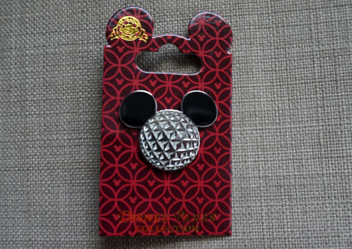 This pin features Spaceship Earth with Mickey ears.